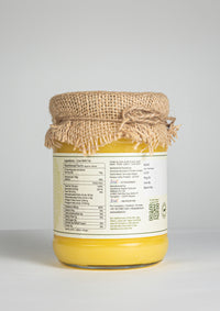 Back side of Ekaris A2 Gir Cow Ghee glass jar showing nutrition facts and product details with jute cover