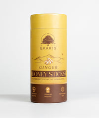 Front view of Ekaris Ginger Honey Sticks yellow and brown cylindrical pack on white background showing Immunity Booster, Premium Produce and Antioxidant Rich labels