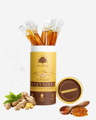Ekaris Ginger Honey Sticks cylindrical pack with honey sticks, fresh ginger root, green leaves and honeycomb on white background