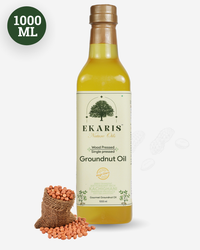 Ekaris Kachighani Wood Pressed Single Pressed Groundnut Oil 1000ml glass bottle with peanuts in jute bag on light background