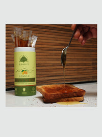 Ekaris Organic Lemon Honey Sticks honey being drizzled on toast for breakfast