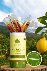 Ekaris Lemon Honey Sticks tube with certified organic nectar lid and fresh lemon against Himalayan mountain backdrop
