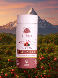Ekaris Organic Honey Litchi Flavored Sticks tube against Himalayan sunset with lush litchi orchard background