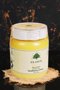 Ekaris Select VedRatna Bilona Method A2 Desi Cow Ghee container placed on rustic fabric background