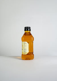Back view of Ekaris Yellow Mustard Oil bottle showing label on white background