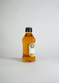 Back side of Ekaris Yellow Mustard Oil bottle with QR code on clean white background