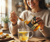 Woman adding Ekaris Ginger Honey into hot lemon tea using wooden spoon with fresh ginger root on wooden table — pure honey brand in India